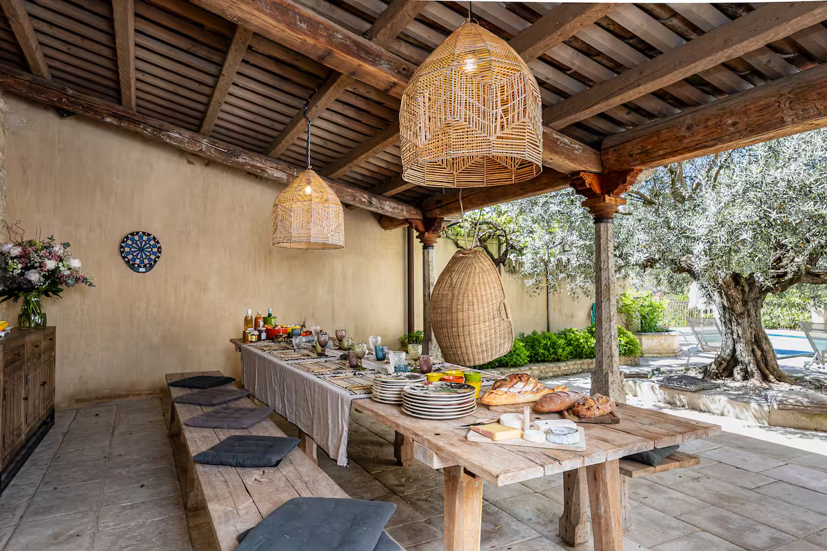 Outdoor dining under olive tree